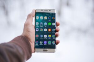 Mobile phone displays a user navigating to the menu to reset privacy settings and disable Android phone tracking for enhanced privacy and security.
